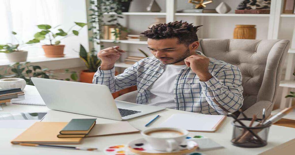 An influencer using a laptop and smartphone promoting Amazon products.